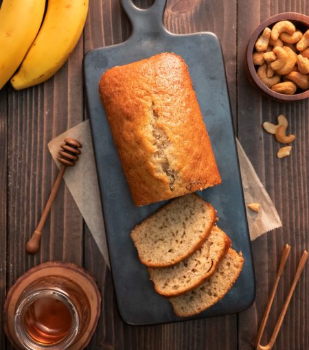 Homemade banana bread pound sliced with cashew nuts and honey on